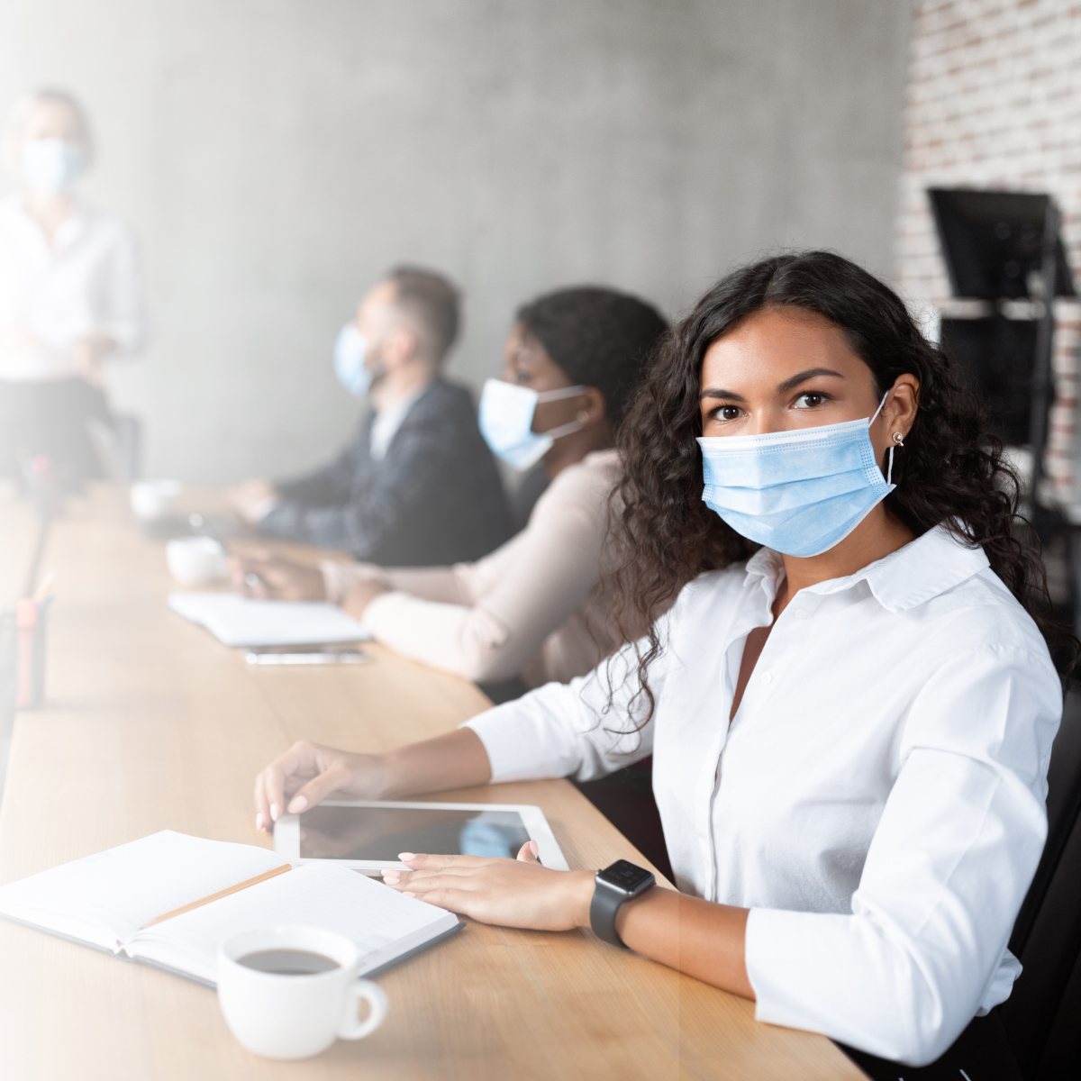 Businesswoman In Face Mask Sitting Attending Corporate Meeting In Office