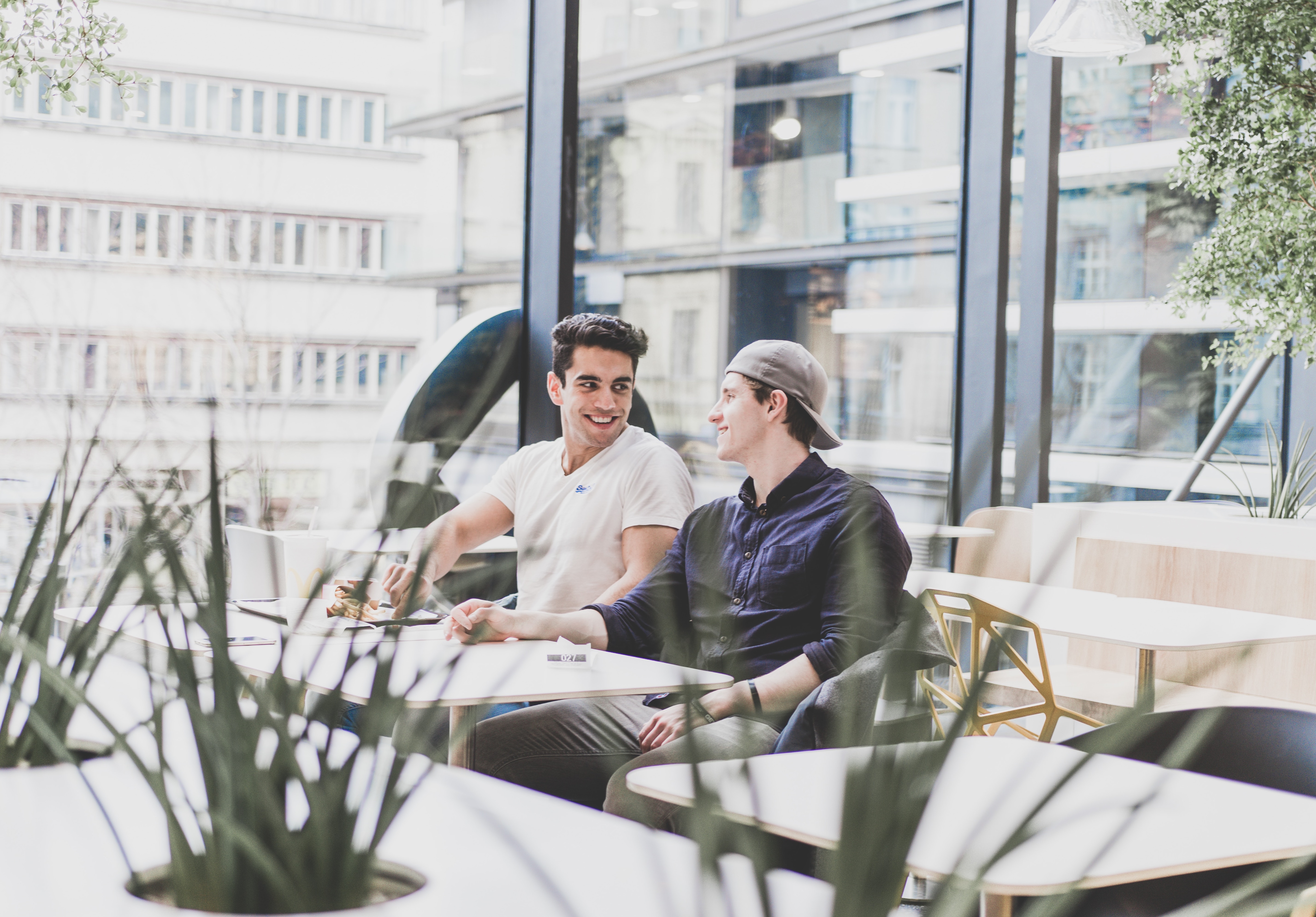 Two young workers in an office photo by Kenan Buhic via Unsplash