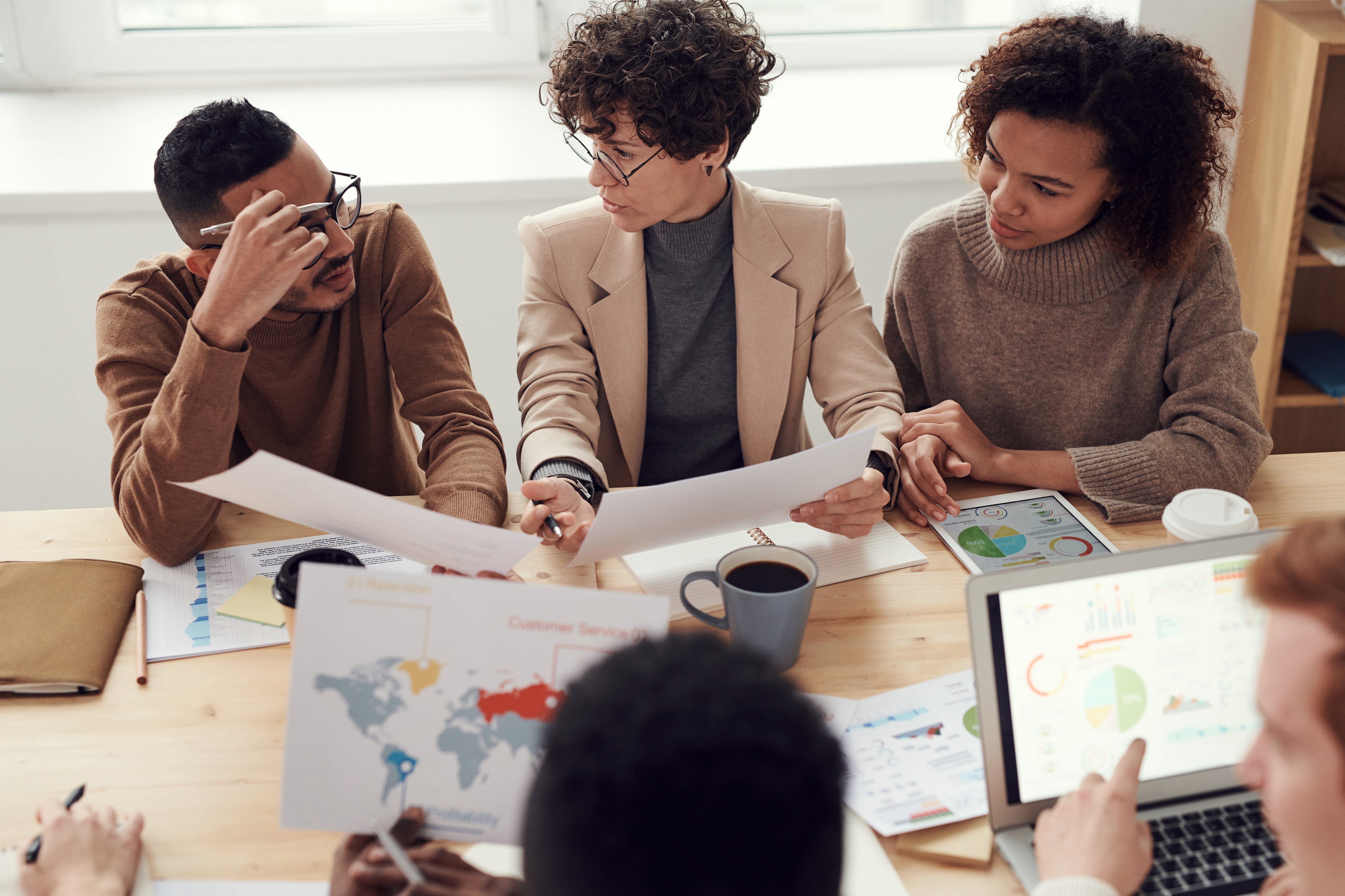 photo-of-people-sitting-near-table-holding-photo by fauxels via unsplash